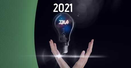 Composition of green copy space over year 2021, hand and idea in lightbulb, on black