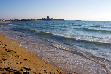 Beautiful seascape. Golden sand beach. Summer Idyllic  scenery. Calm blue water. Vacation time. Sun reflections on blue sea water. Evening on a beach. Calm waves and golden sand. Summer scenery.