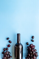 Red wine bottle with grape. Overhead view