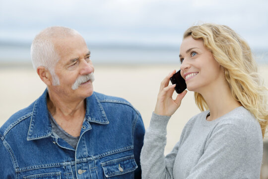 mature man with woman using a mobile phone