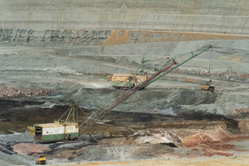 large excavator loads rock with iron or bauxite mining