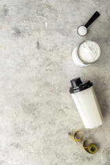 Obraz na płótnie Canvas Sport nutrition - whey protein powder and shaker with protein smoothie