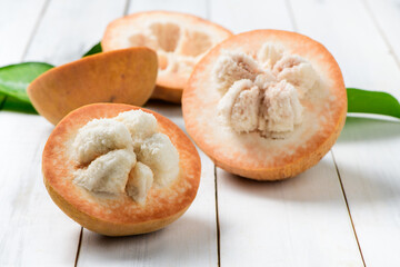 Half Santol on wood background, famous fruit of Lopburi Province. THAILAND