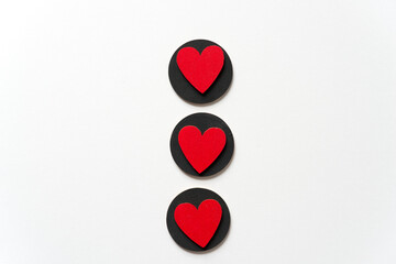 isolated red hearts on black circles on white