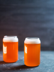 Two glasses of wheat beer on a dark table