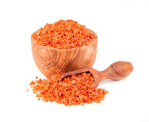 Dry carrot in olive bowl and scoop, isolated on the white background. Chopped dried carrot. Spices and herbs.