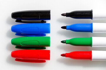 Four multicolored markers on a white background