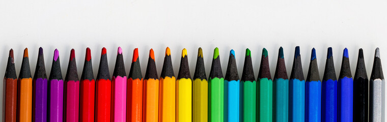 Set for artist and drawing. Multi-colored pencils on white background