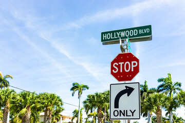 Hollywood, Florida city town in Broward County with street in sunny day in North Miami Beach area with sign for boulevard and stop