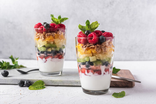 Delicious yogurt with assorted fruits in glasses
