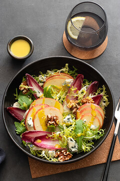 Colorful delicious salad with endives, apple and roquefort cheese