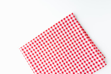 Abstract fabric checkered red and white, isolated on a white background with copy space. Top view tablecloth texture.