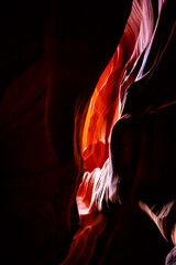 Vertical view of dark shadows and light at upper Antelope slot canyon with wave shape rock sandstone in Page, Arizona
