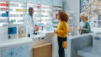 Foto op Canvas Pharmacy Drugstore Checkout Counter: Professional Black Pharmacist Provides Best Customer Service to Diverse Group of Multi-Ethnic Clients Buying Medicine Paying with Contactless Payment Credit Cards © Gorodenkoff