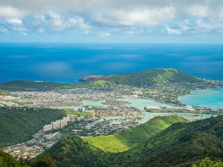 The view overlooking the town.  Blue sky over green mountains. Amazing view of the ocean. 
 Kuliouou Ridge Trail, Hawaii, Oahu