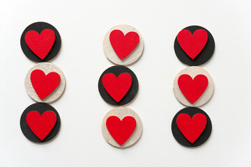 hand painted red and black shapes (hearts and circles) - loosely arranged on a light background - photographed from above under ambient light conditions