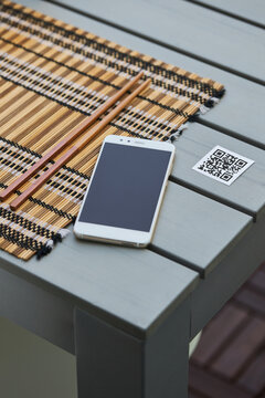 Smartphone and QR code of menu in restaurant