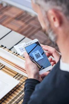 Crop man scanning QR code of restaurant menu