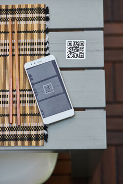 Smartphone and QR code of menu in restaurant