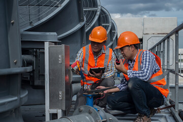 workers at work.  engineer inspection cooling  Tower plant. engineer inspection safety switch on...