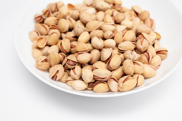 Pistachios nuts in white bowl