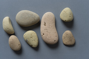 Fototapeta na wymiar porous stones on medium gray background