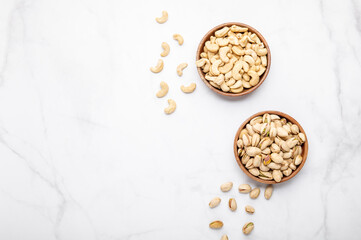 Cashew and pistachios nuts in wooden bowls