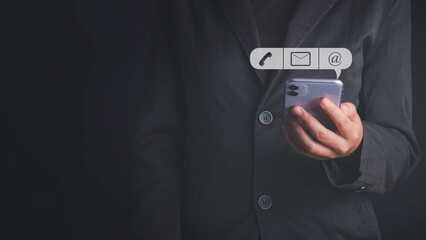 CONTACT US, Customer support, Customer service concept. Businessman holding mobile smartphone with ( mail,phone,email ) icon ,copy space.