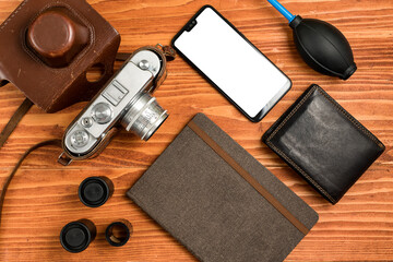 Journalistic equipment - notebook, phone, camera, lens, wallet and different objects. Vintage and modern concept. Freelancers outfit. Clipping mask for screen