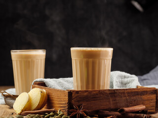 Traditional Indian drink masala chai on a wooden table,Copyi space. - obrazy, fototapety, plakaty