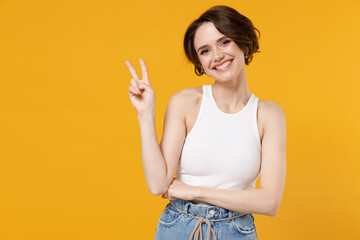 Young cheerful friendly smiling happy woman 20s with bob haircut in white tank top shirt show...