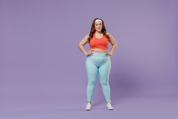 Fototapeta na wymiar Full length young chubby overweight plus size big fat fit woman wear red top warm up training stand akimbo arm on waist isolated on purple background studio home gym. Workout sport motivation concept.