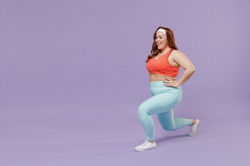 Full length side view happy young chubby overweight plus size big fat fit woman in red top warm up train squating lunges with legs isolated on purple background gym. Workout sport motivation concept. - obrazy, fototapety, plakaty