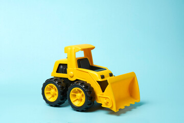 yellow toys bulldozer on blue background