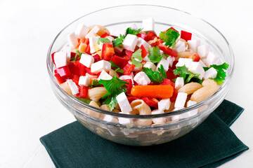 Pasta salad with green beans, baby carrots, bell pepper, corn and feta cheese in the glass bowl. Mediterranean cuisine meal