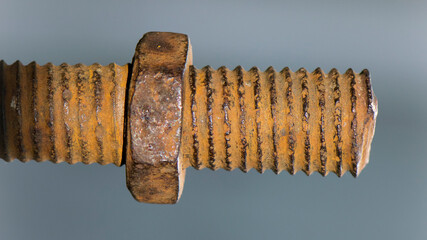 old rusty bolt, iron rod with screw threads. Rusted mechanical components. threaded bolt and nut isolated close up. dismantling concept, difficult to unscrew, non-removable. selective focus