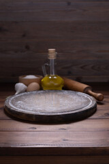 Obraz na płótnie Canvas Pizza cutting board and food ingredient for homemade bread cooking on table. Wooden tabletop