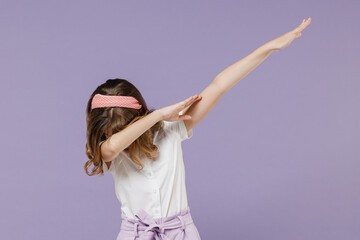 Little kid girl 12-13 years old in white shirt doing dab hip hop dance hands move gesture youth sign hide cover face isolated on purple background children studio portrait Childhood lifestyle concept