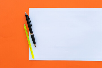 Blank sheet of paper with colored pens on the side