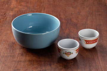 one empty blue bowl and two empty cups of classic chinese tea    