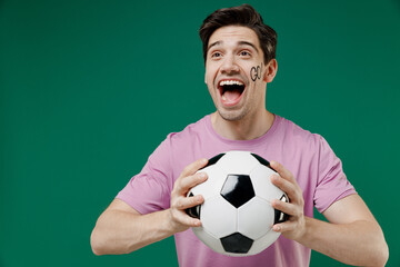 Young fun european man fan supporter wears basic pink t-shirt cheer up support football sport team...