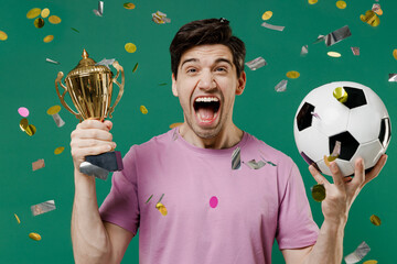 Young fun man fan wear basic pink t-shirt cheer up support football sport team hold in hand soccer...