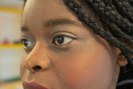 Close Up Of Black African American Young Woman Girl Eyes. Texture Of The Black Eye Is Visible. Macro Detail Of Iris.