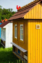 Colored bee houses on green meadow in countryside. Honey bee hives. Beautiful small decorative houses.