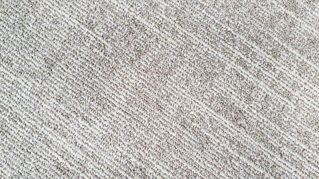 close up of monochrome of white and beige carpet texture background for interior flooring material. office carpet background. luxury polypropylene and polyester rug.