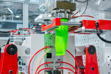 Automatic blow molding machine - manufacturing of empty green plastic jerrycans at factory,...