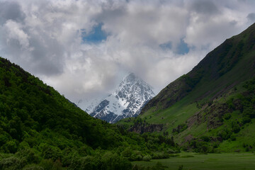 The top of the Tikhtengen mountain range against the backdrop of green mountain slopes
