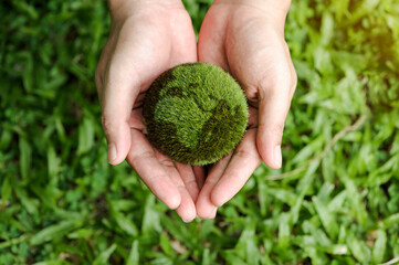 top viewof hands holding the earth on a green background. protect nature. Save Earth. concept of...