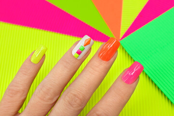 Bright illuminated multicolored manicure with rhinestones.