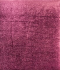 The purple velvet-soft textured fabric close up